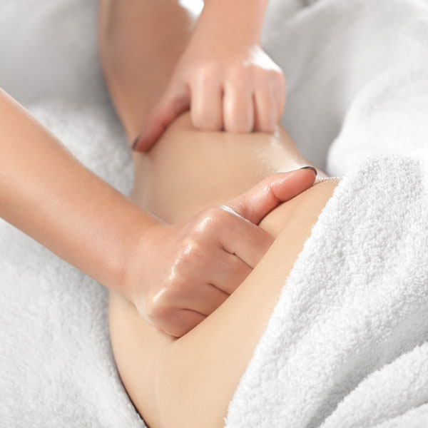 closeup of individual receiving thigh massage for lymphatic drainage
