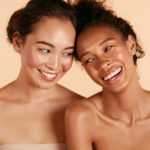two women with clean faces laughing