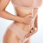 closeup of woman's midsection with hands on their stomach