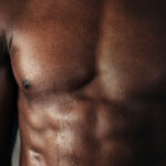 closeup of man's chest with water dripping