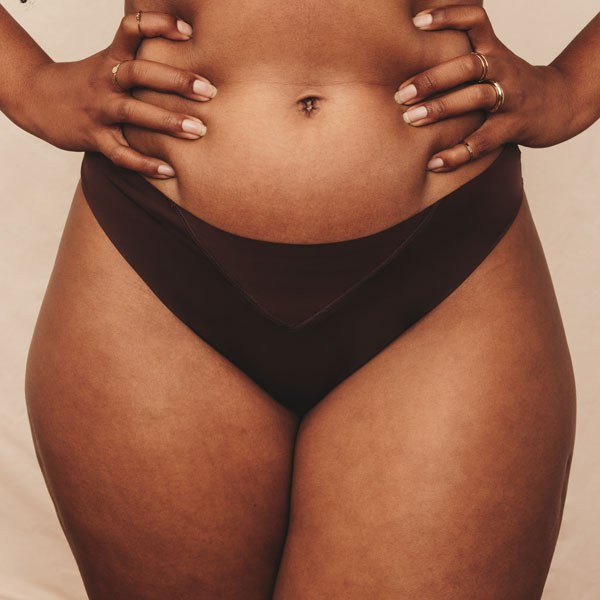 closeup of woman's waist with her hands on her hips