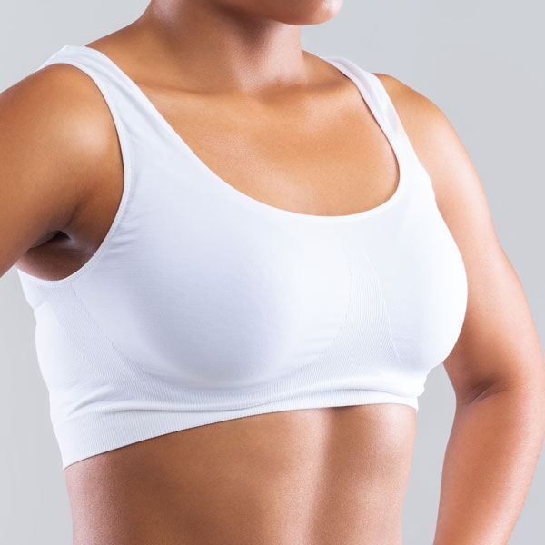 closeup of woman in white sports bra
